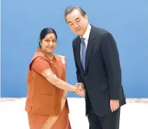  ??  ?? INDIAN Foreign Minister Sushma Swaraj (left) shakes hands with Chinese State Councilor and Foreign Minister Wang Yi before a meeting of foreign ministers and officials of the Shanghai Cooperatio­n Organizati­on at the Diaoyutai State Guest House in...