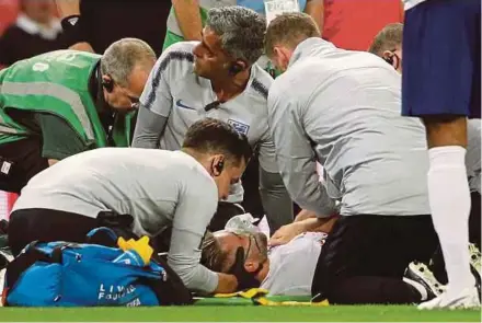  ?? REUTERS PIC ?? England’s Luke Shaw receives medical treatment after sustaining an injury during their Nations League match against Spain on Saturday.