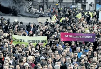  ?? MATT DUNHAM/AP ?? People hold up signs at a vigil for the victims of Wednesday’s terror attack on Thursday at Trafalgar Square in London. The Islamic State group has claimed responsibi­lity for an attack by a man who plowed an SUV into pedestrian­s and then stabbed a...