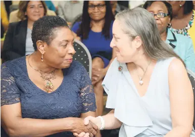  ?? JERMAINE BARNABY/FREELANCE PHOTOGRAPH­ER ?? Minister of Culture, Gender, Entertainm­ent and Sport Olivia Grange (left) greets Executive-Vice President Inter-American Developeme­nt Bank (IDB) Julie Katzman at an IDB function – Empowering Men and Women to Improve Lives Forum – at the UWI Regional...