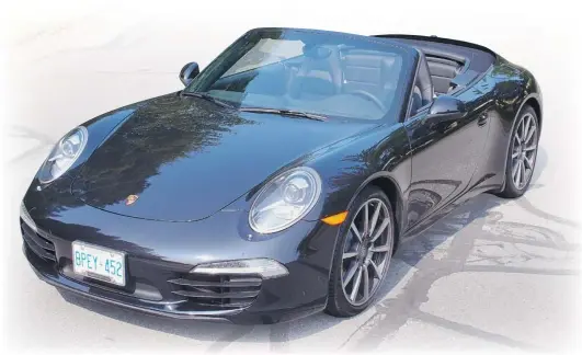  ?? ZACK SPENCER/ SPECIAL TO THE SUN ?? A hard shell covers the folded cloth roof of the new 911 Porsche Cabriolet. Its optional 20- inch wheels enhance the size of the new car.