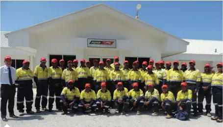  ??  ?? Process Operators in front of White Haus - Refinery Admin Building We firmly believe the diversity of nationalit­ies, cultures and experience across our team is a great strength for Puma Energy
