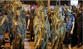  ?? REUTERS ?? Hamas militants march during an anti-Israel rally in Gaza City on 8 July to mark the one-year anniversar­y of the war between Israel and Hamas in Gaza.