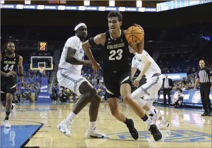  ?? RAUL ROMERO JR. — THE ASSOCIATED PRESS ?? Colorado forward Tristan da Silva dribbles past UCLA forward Adem Bona, center left, on Thursday in Los Angeles.