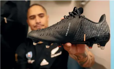  ?? GETTY IMAGES ?? Aaron Smith holds up his boot with his newborn son’s name on it after the Rugby World Cup game against the Springboks last year.