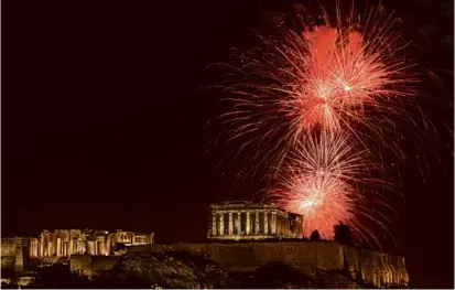  ?? YORGOS KARAHALIS/ASSOCIATED PRESS ?? Fireworks exploded over the ancient Parthenon temple at the Acropolis hill in Athens.