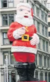  ?? PHOTO: THE NEW ZEALAND HERALD ?? Ho ho go . . . The giant Santa seen on the Whitcoull’s building, in central Auckland.