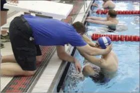  ?? NICOLE CHAN — WOODLAND PARK PRODUCTION­S LLC (VIA AP) ?? Jersey Hammerhead­s swimmer Michael McQuay and his father and coach, Mike, are shown in April 2016 during a sectional swim meet for the Special Olympics in Neptune, N.J.