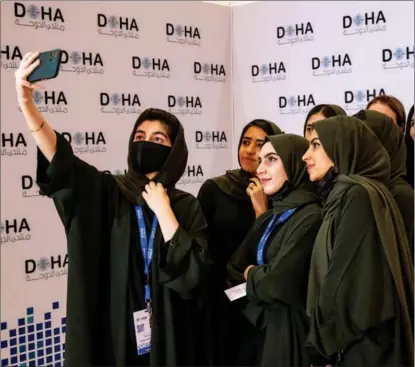  ?? AMMAR ABD RABBO / DOHA FORUM / AFP ?? Members of the Afghan Girls Robotics Team take a selfie at the Doha Forum in Qatar on March 27.