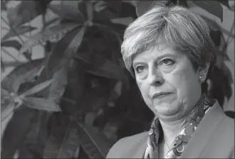  ?? The Associated Press ?? British Prime Minister Theresa May listens as the declaratio­n at her constituen­cy is made in the general election in Maidenhead, England, Friday.