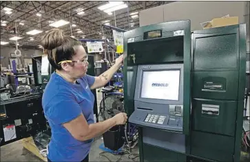  ?? Gerry Broome Associated Press ?? ATM MAKER Diebold Nixdorf also saw its bonds collapse. Above, a factory in Greensboro, N.C., in 2017.