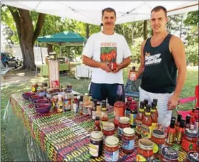  ?? LISA MITCHELL - DIGITAL FIRST MEDIA ?? Dan Faust and his son Hayden, 23, offered salsa and hot sauce tastings for their family business Smokin’ Peppers of Fleetwood.