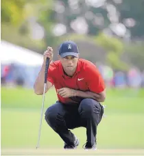  ?? ASSOCIATED PRESS FILE ?? Tiger Woods lines up a putt during the final round of the Arnold Palmer Invitation­al in March 18 in Orlando, Fla. Woods is returning to the Masters and has been installed as a co-favorite.