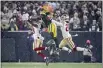  ?? AARON GASH — THE ASSOCIATED PRESS ?? The Green Bay Packers’ Davante Adams can’t catch a pass between the San Francisco 49ers’ Dontae Johnson and Talanoa Hufanga during the second half of an NFC divisional playoff game Saturday in Green Bay, Wis.