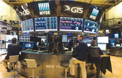  ??  ?? NEW YORK: Traders work on the floor at the closing bell of the Dow Industrial Average at the New York Stock Exchange in New York.—AFP