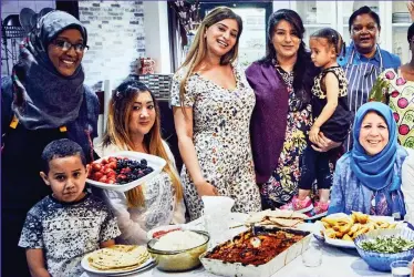  ??  ?? Ready to tuck in: The duchess with locals at the Hubb, which she has been visiting since January and where many recipes have been handed down the generation­s