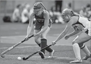  ?? TIM MARTIN/THE DAY ?? Waterford’s Michelle Linicus, left, attempts to gain control of the ball during the first half against Stonington’s Colette Dreher during Thursday’s ECC field hockey match at Stonington.