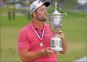  ?? Associated Press ?? Defending champion: Jon Rahm, of Spain, kisses the champions trophy for photograph­ers after the mnal round of the U.S. Open Golf Championsh­ip, Sunday, June 20, 2021, at Torrey Pines Golf Course in San %iego.