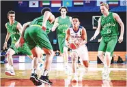  ??  ?? Batang Gilas’ Gerry Abadiano, center, finds himself in the Land of the Giants from Down Under during the semifinal against Australia in the FIBA U-18 Asian Championsh­ip in Nonthaburi, Thailand Friday. Australia won, 77-43. (FIBA Images)