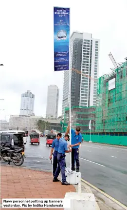  ??  ?? Navy personnel putting up banners yesterday. Pix by Indika Handuwala