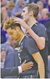  ?? THE ASSOCIATED PRESS ?? Vanderbilt’s Luke Kornet, right, consoles guard Matthew Fisher-Davis after the team’s 68-66 loss to Northweste­rn.