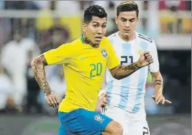  ?? FOTO: AP ?? Firmino en el último partido de Brasil ante Argentina con Dybala