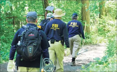  ?? Hearst Connecticu­t Media file photo ?? Members of an FBI Evidence Response Team searched Waveny Park in New Canaan near the bridge that carries Lapham Road over the Merritt Parkway on June 3, 2019, as part of the Jennifer Dulos case.