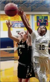  ?? GREGG SLABODA — TRENTONIAN PHOTO ?? Hopewell’s Addie Danieluk, left, and Nottingham’s Patricia Penix, right, battle for the rebound during Thursday night’s game. Story on page 39.