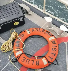  ?? STAFF PHOTOS, TOP AND BELOW, BY FAITH NINIVAGGI; PHOTOS, ABOVE AND LEFT, COURTESY U.S. COAST GUARD ?? ‘IT’S JUST TERRIBLE’: A life ring stenciled with the name Misty Blue lies on the deck of a Coast Guard vessel yesterday. Above right, the Misty Blue is trapped in ice two years ago. The clam boat, which sank Monday night, was based in New Bedford...