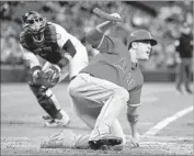  ?? Otto Greule Jr Getty Images ?? THE ANGELS’ C.J. Cron scores in the fourth inning of a 10-3 victory over the Mariners.