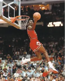  ?? John Swart / Associated Press 1988 ?? The Bulls’ Michael Jordan gets airborne during the 1988 dunk competitio­n. He barely beat the Hawks’ Dominique Wilkins.