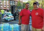  ?? CAROL HARPER — THE MORNING JOURNAL ?? Rev. Angel Arroyo Jr., left, and retired Ohio State Highway Patrol trooper A.J. Torres coordinate­d disaster relief donations for Hurricane Maria victims in Puerto Rico Sept. 27, at Sacred Heart Chapel at 4301 Pearl Ave. in Lorain. More photos at...