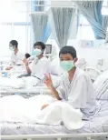  ?? Pictures: Gallo/Getty Images/Reuters ?? Boys rescued from the Thai cave wearing masks and resting in hospital.