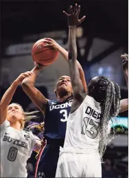  ?? Michael Conroy / Associated Press ?? UConn forward Aaliyah Edwards (3) is fouled as she shoots between Butler guard Micah Scheetz (0) and forward Nyamer Diew (13) on Saturday.