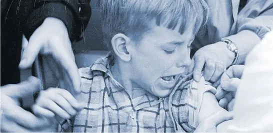  ?? LIBRARY AND ARCHIVES CANADA / NATIONAL FILM BOARD ?? A Canadian boy being vaccinated in 1959. He would be in the first generation where shots turned polio, diphtheria, smallpox and whooping cough into anomalies.