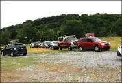  ?? Photos by Jake Mercer ?? Vehicles were bumper to bumper Monday afternoon as State Rep. Mike Armanini held his first license plate replacemen­t event in Elk County.