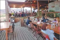  ?? NICOLE EVATT / AP ?? People dining at the steakhouse Finca Altozano, which includes sweeping views of Valle de Guadalupe in Ensenada Municipali­ty, Baja California, Mexico.