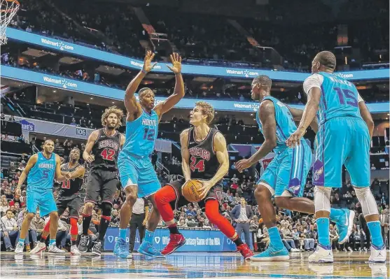  ?? | NELL REDMOND/ AP ?? Forward Lauri Markkanen ( 24) had a team- high 24 points ( 8- for- 15 shooting) and 12 rebounds in the Bulls’ 119- 111 overtime victory over the Hornets on Friday.