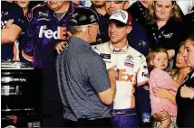  ?? JARED C. TILTON / GETTY IMAGES ?? Daytona 500 winning driver Denny Hamlin, who was discovered and signed by J.D. Gibbs, celebrates in victory lane Sunday night with JGR team owner Joe Gibbs.