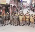  ?? PHOTO: PTI ?? Policemen stand guard during the third and last day of a videograph­ic survey at Gyanvapi Mosque complex in Varanasi, on Monday