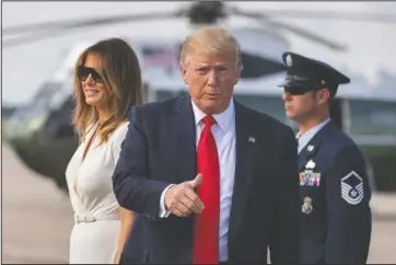  ?? The Associated Press ?? ARRIVAL: President Donald Trump with first lady Melania Trump gestures upon arrival at Andrews Air Force Base, Md., Sunday.