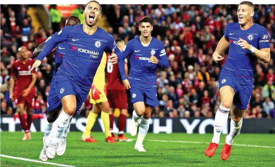  ??  ?? Eden’s got the wow factor: Hazard wheels away after his wondergoal clinched a dramatic late victory for Chelsea at Anfield