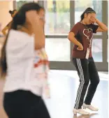  ??  ?? Left: Camila Quezadas, 12, of San Jose, wipes her brow as she takes part in an advanced folklorico workshop. The threeday festival offers workshops in mariachi, dance and cultural folklore for a new generation of learners.