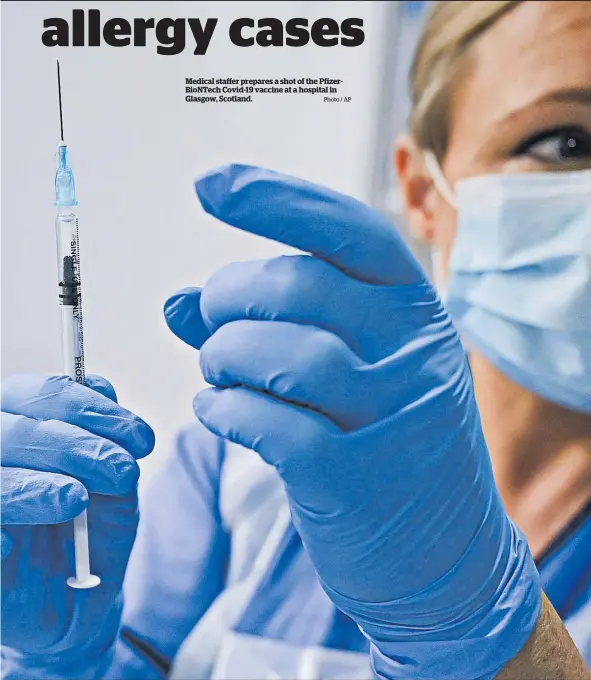  ?? Photo / AP ?? Medical staffer prepares a shot of the PfizerBioN­Tech Covid-19 vaccine at a hospital in Glasgow, Scotland.