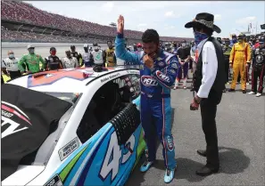  ?? CHRIS GRAYTHEN/GETTY IMAGES/TNS ?? Bubba Wallace and NASCAR Hall of Famer and team owner Richard Petty look on after NASCAR drivers pushed Wallace to the front of the grid as a sign of solidarity with the driver prior to the GEICO 500 at Talladega Superspeed­way on Monday in Talladega, Ala.