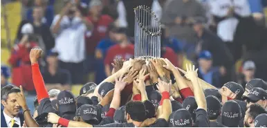  ?? (Richard Mackson/USA TODAY Sports/Reuters) ?? BOSTON RED SOX players celebrate with the Commission­er’s Trophy after defeating the Los Angeles Dodgers in game five of the 2018 World Series at Dodger Stadium.