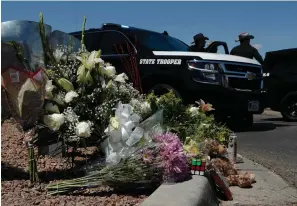  ?? Associated Press ?? ■ Flowers adorn a makeshift memorial Sunday near the scene of a mass shooting at a shopping complex in El Paso, Texas.