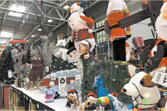  ?? DAVID ZALUBOWSKI/AP ?? A Lowe’s store displays Christmas decoration­s Oct. 2 in Colorado. Retailers are starting the holiday season earlier than ever.