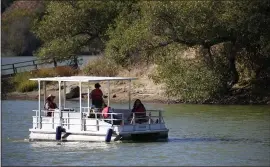  ?? PHOTOS BY JANE TYSKA — STAFF PHOTOGRAPH­ER ?? Boaters cool off under a shade canopy while motoring on Lake Chabot in Castro Valley.