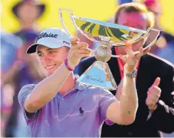  ?? CURTIS COMPTON/ATLANTA JOURNAL-CONSTITUTI­ON VIA AP ?? Justin Thomas holds the trophy after winning the FedEx Cup at East Lake Golf Club in Atlanta on Sunday.